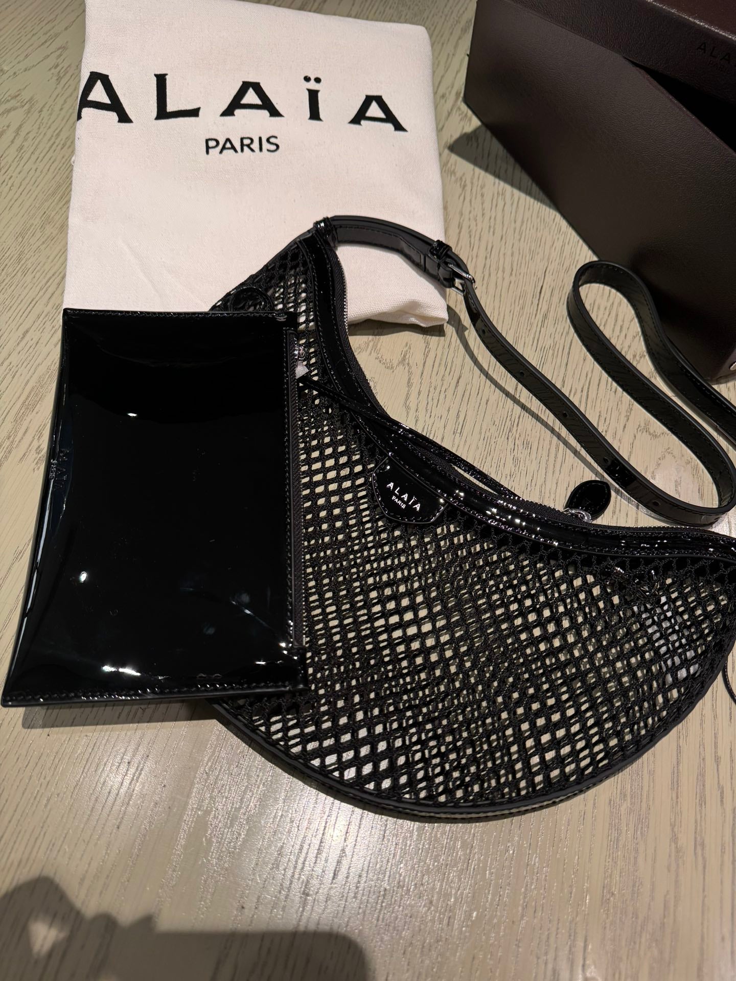 ALAIA ONE PIECE half-moon bag black patent leather 243053