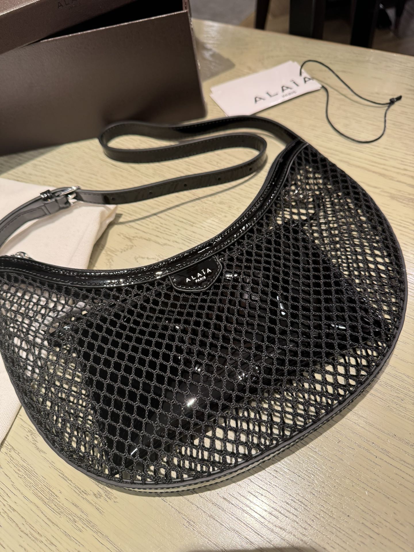 ALAIA ONE PIECE half-moon bag black patent leather 243053