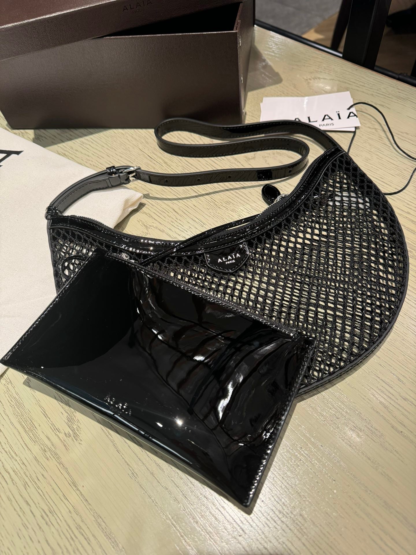 ALAIA ONE PIECE half-moon bag black patent leather 243053