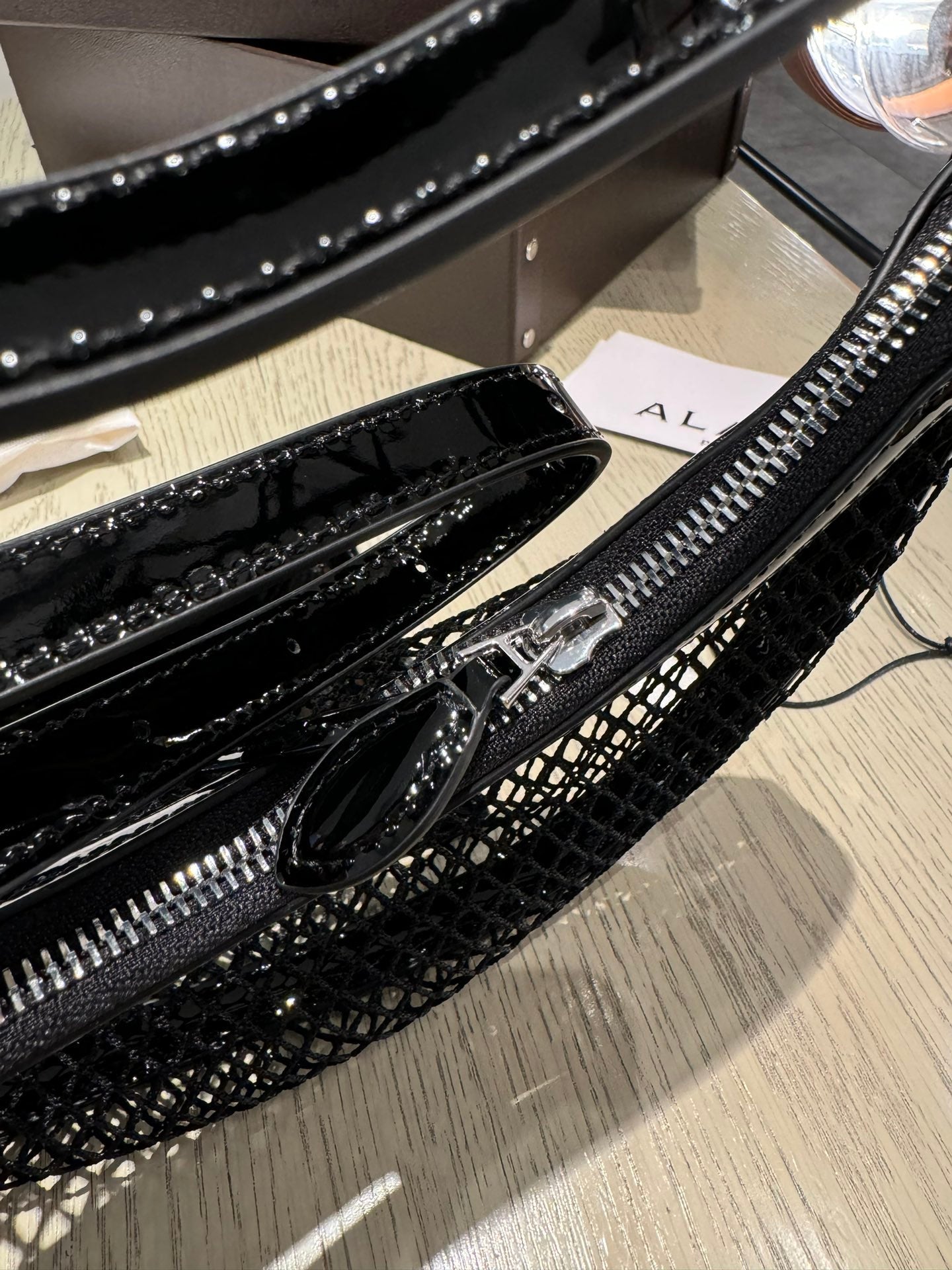 ALAIA ONE PIECE half-moon bag black patent leather 243053