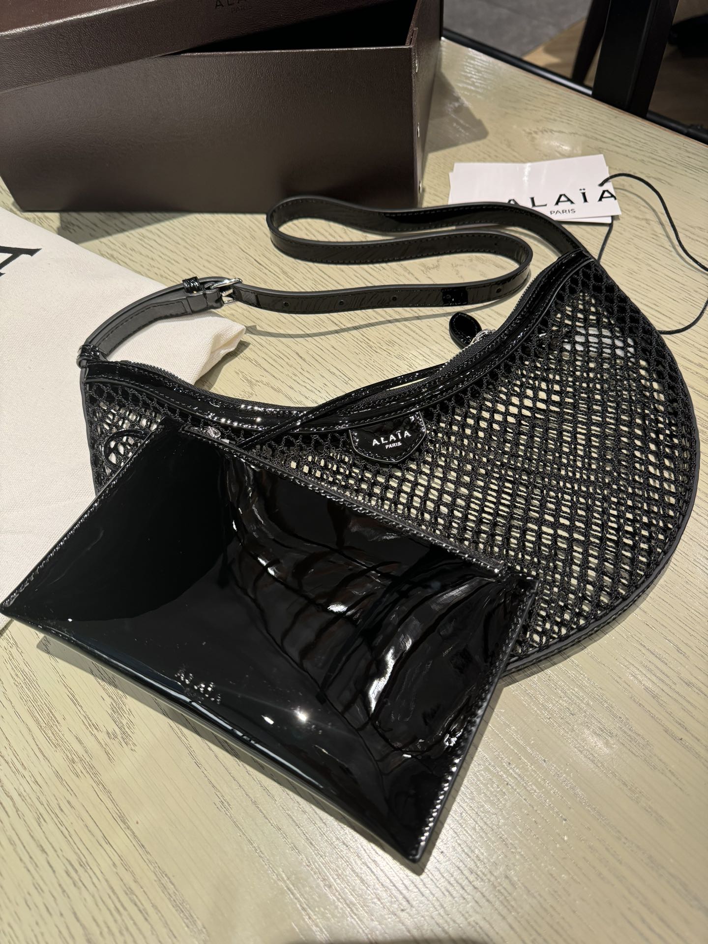 ALAIA ONE PIECE half-moon bag black patent leather 243053