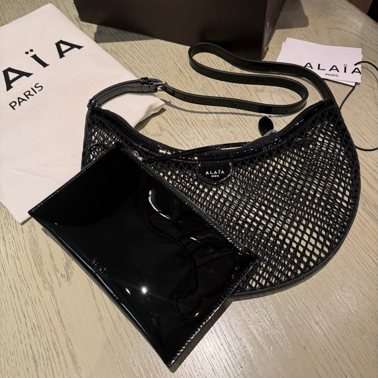 ALAIA ONE PIECE half-moon bag black patent leather 243053