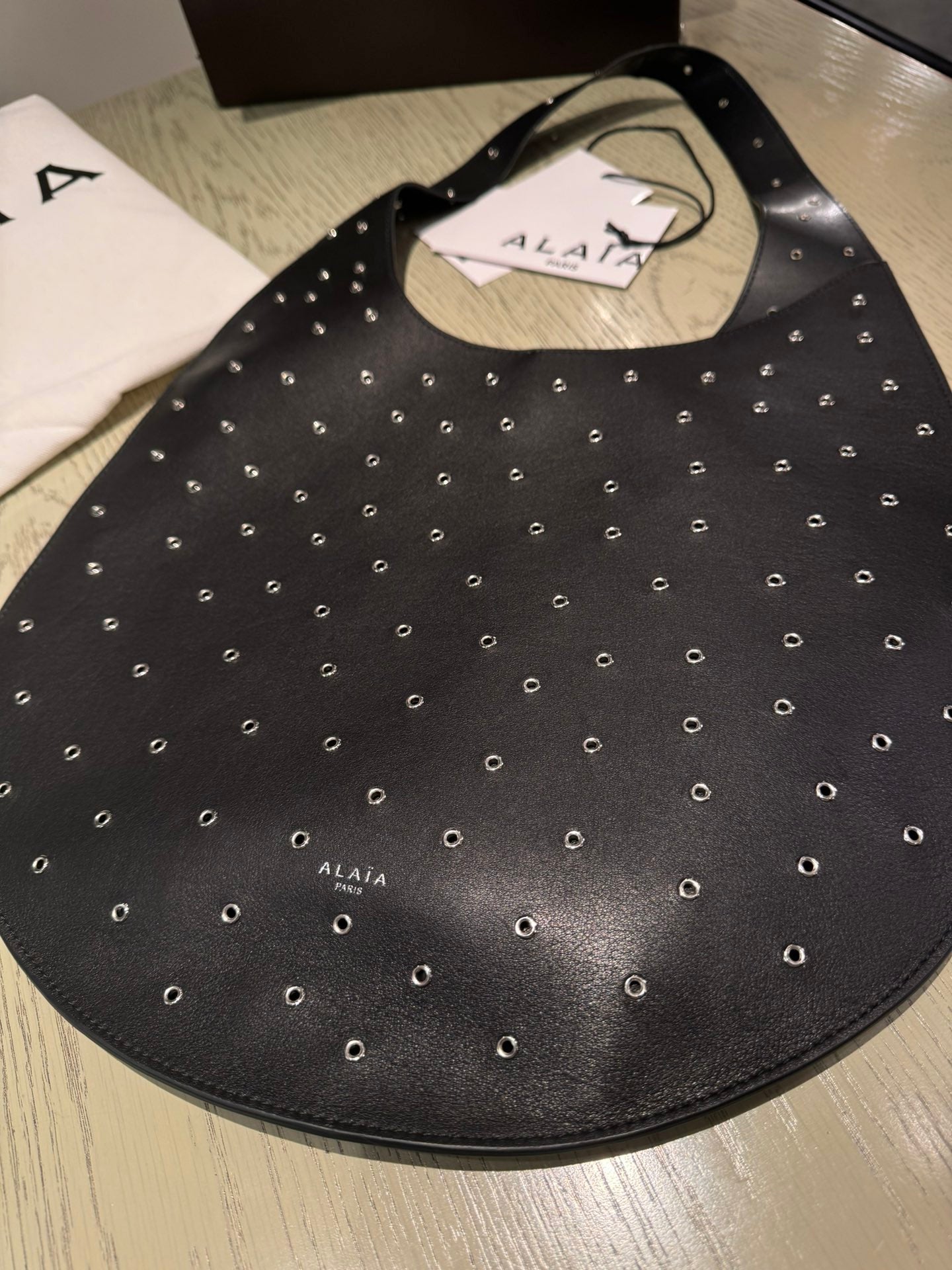 ALAIA Medium Hobo Flat Bag Metal Rivet Black Calfskin 243053