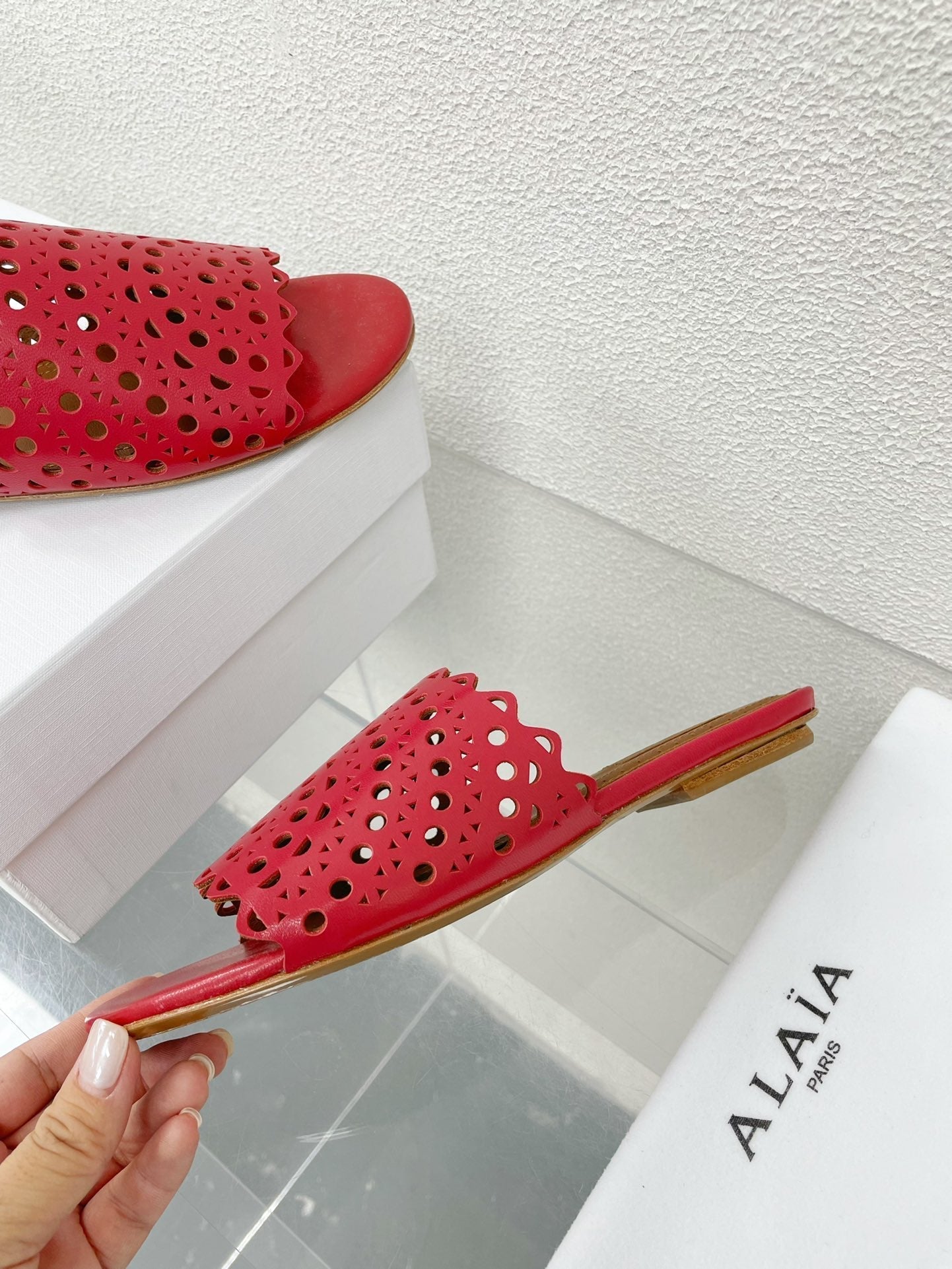 ALAIA VIENNE FLAT MULES IN CHERRY RED LAMBSKIN