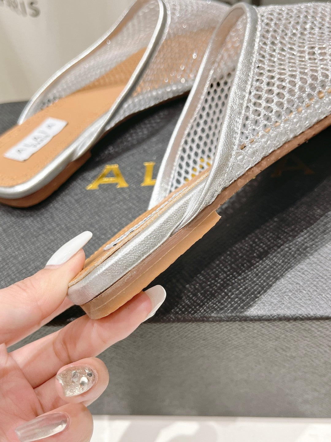 ALAIA FLAT MULES IN SILVER MESH FISHNET