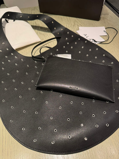 ALAIA Medium Hobo Flat Bag Metal Rivet Black Calfskin 243053