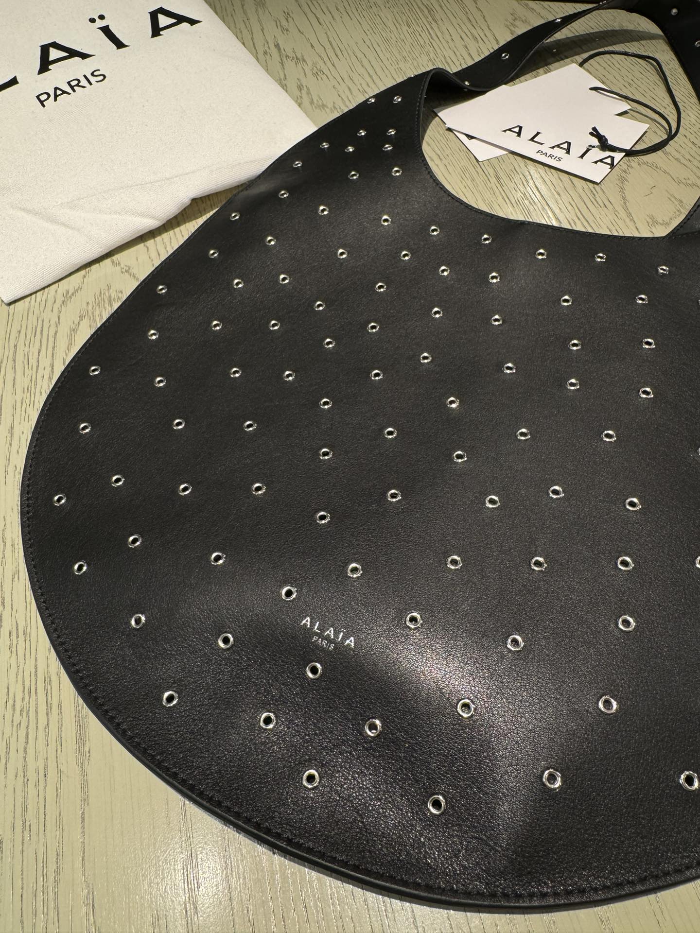 ALAIA Medium Hobo Flat Bag Metal Rivet Black Calfskin 243053