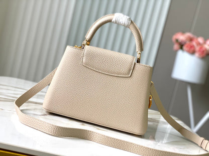 CAPUCINES BB 27CM BEIGE TAURILLON LEATHER