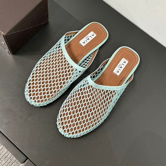 ALAIA FLAT MULES IN LIGHT BLUE MESH FISHNET