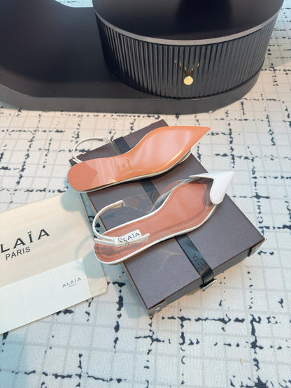 ALAIA FLAT SLINGBACK IN WHITE PATENT CALFSKIN AND FILM