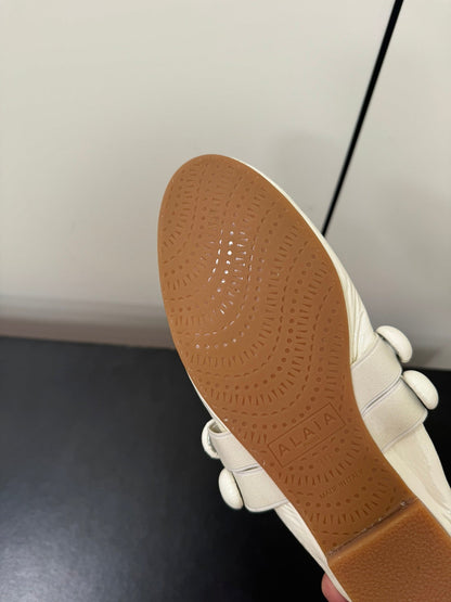 ALAIA SPHERE BALLET FLATS IN WHITE LAMBSKIN