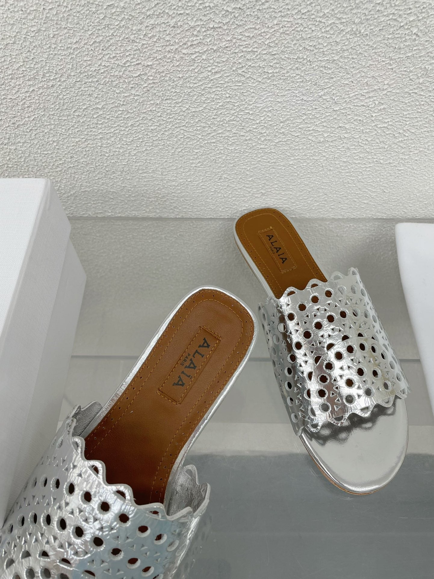 ALAIA VIENNE FLAT MULES IN SILVER LAMBSKIN