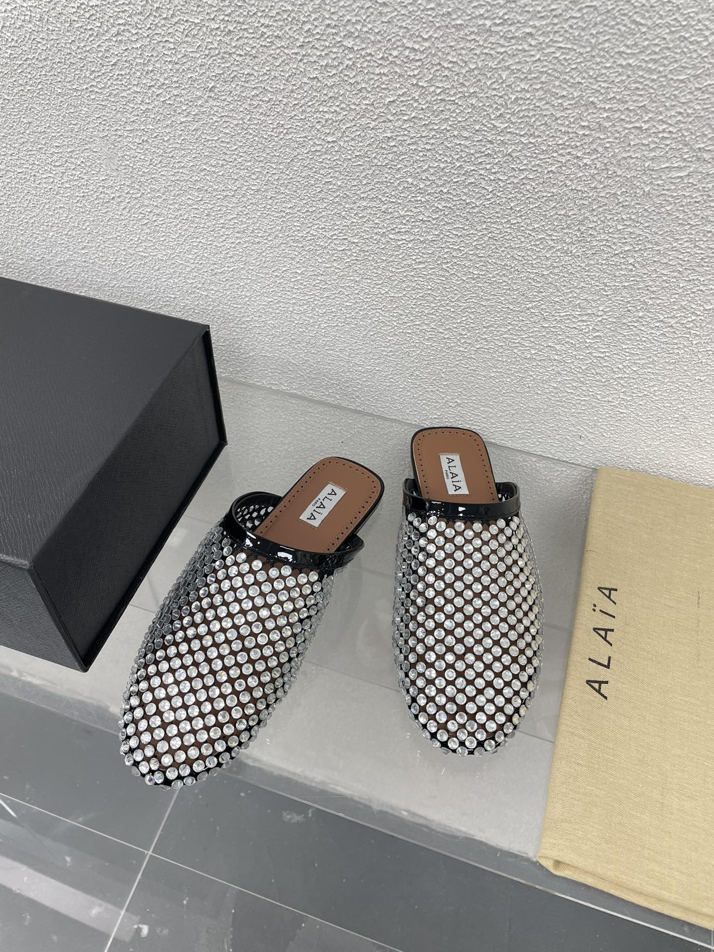 ALAIA FLAT MULES IN STRASS BLACK LAMBSKIN WITH RHINSTONES